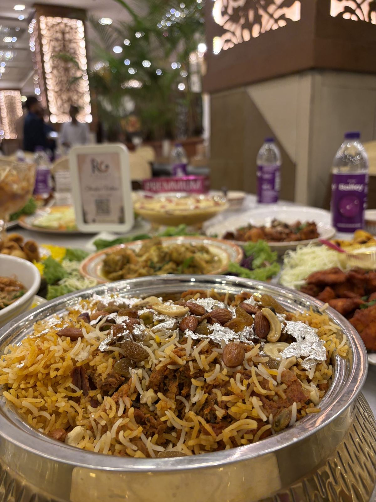 Zafrani mutton dum biryani served from a copper handi by Riwayat Caterers